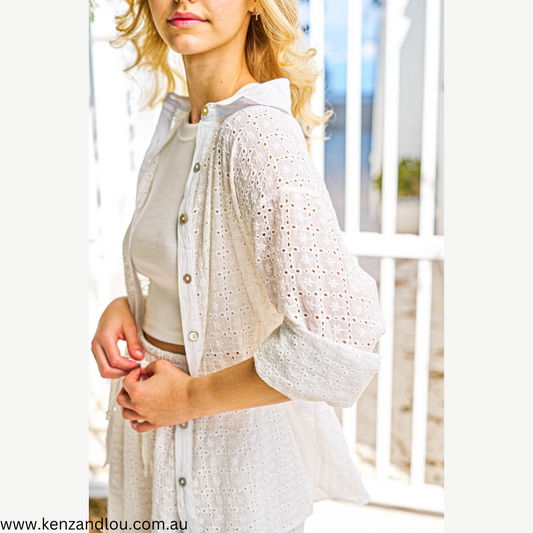 Elevate your style with our White Brodie Anglaise Shirt. Immerse yourself in the luxury of 100% cotton, ensuring unmatched comfort and breathability. The intricate anglaise detailing adds a touch of sophistication, while the shell buttons complete the refined look. Embrace timeless elegance and make a statement in this wardrobe essential. Primrose label boho Kenz&Lou